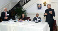 The panelist having a lively interaction with the audience. Also seen is moderator Mr. John Mumford.