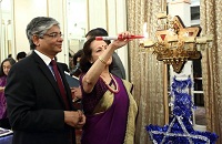 Ambassador Arun K. Singh and Dr. Maina Singh lighting the Menorah, the traditional oil lamp, on the occasion.