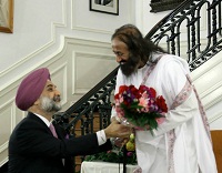 Presentation of bouquet to Sri Sri Ravi Shankar by Charge d'Affaires Ambassador Taranjit Singh Sandhu.