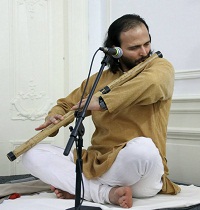 Dr. Birjoo Vaishnav from University of West Georgia and Art of Living Foundation playing the flute as a prelude to the event.