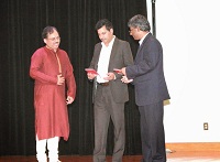 Mr. Ramesh Gola, Director, Chinmaya Mission(Somnath), presenting a Chinmaya Mission publication to officers Mr. A.K. Berwal and Mr. Prem Kumar, who represented Indian Embassy for the event.